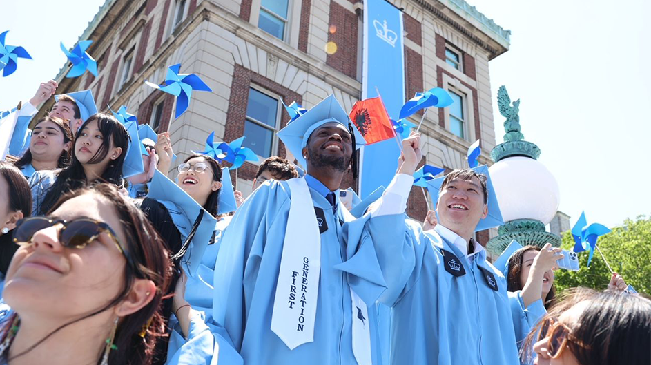 Students hold pinwheels at Commencement