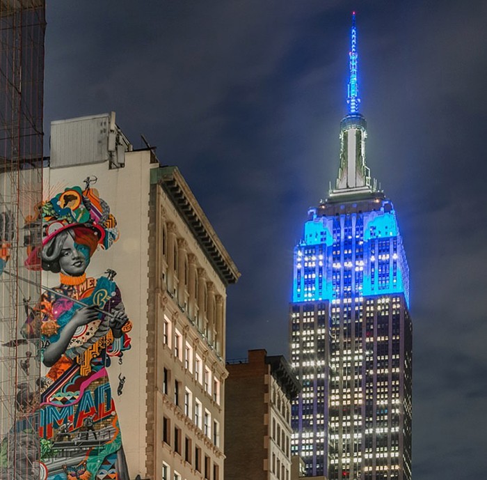 Photo by @nyclovesnyc. The Empire State Building image ® is a registered trademark of ESRT Empire State Building, L.L.C. and is used with permission. Painted Lady Mural with Empire State Building