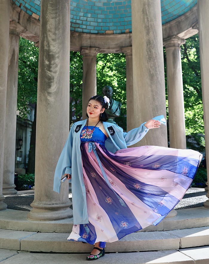 A Columbia graduate poses on Van Am Quad