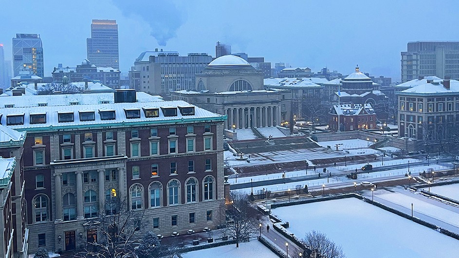 Morningside campus showing Low Library, South Lawn, Pulitzer Hall, and other buildings blanketed in snow at Columbia University. 