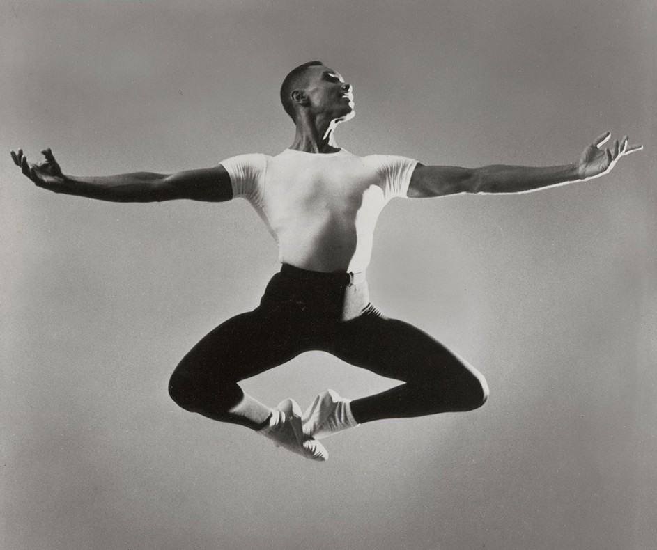 Ballet dance pioneer Arthur Mitchell leaps across the stage in a 1985 Dance Theatre of Harlem production.