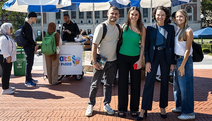 Photo by April Renae. Katrina Armstrong poses with students at "Treats ont he Plaza"