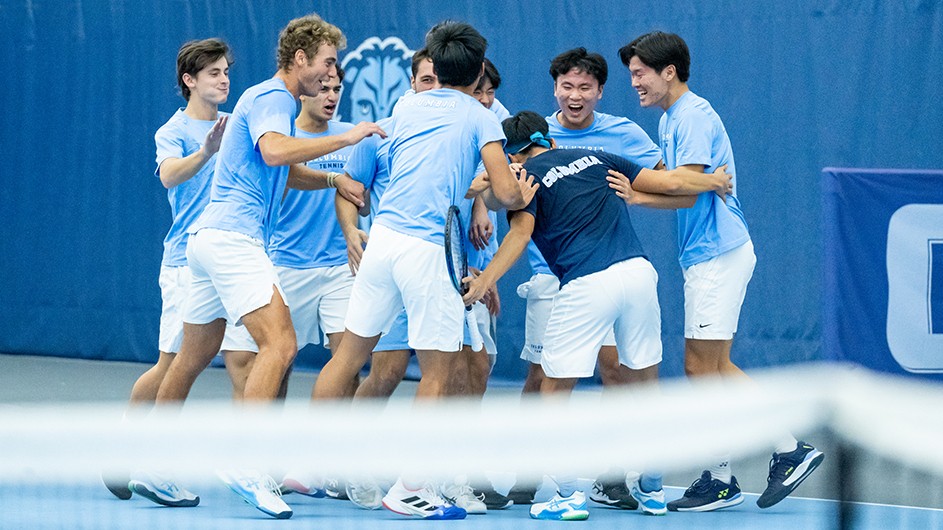 The Columbia Men's Tennis team celebrate on the court after clinching the Ivy League title against Harvard.