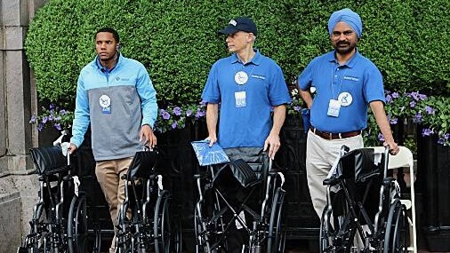 Columbia staff with wheelchairs for graduation attendees