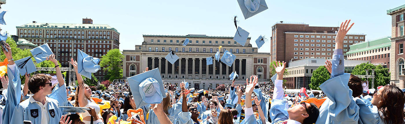 alumni throw their hats in the air