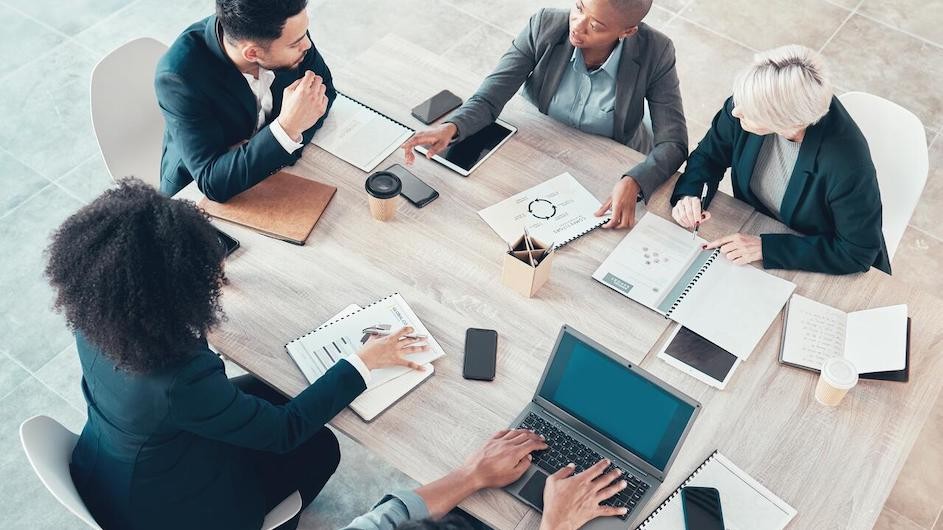People sitting at a table at a business meeting.