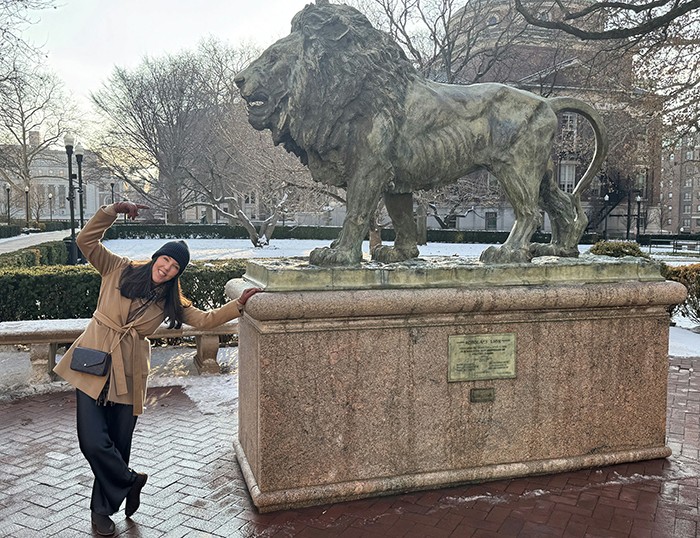 Corina Stone poses with scholars Lion