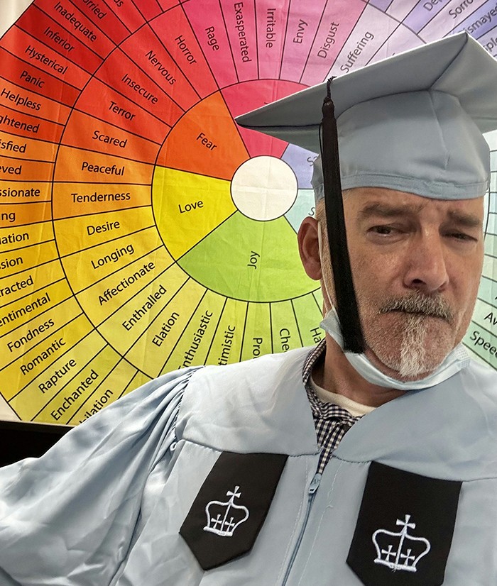 Vincent Mas poses in front of his research poster. 