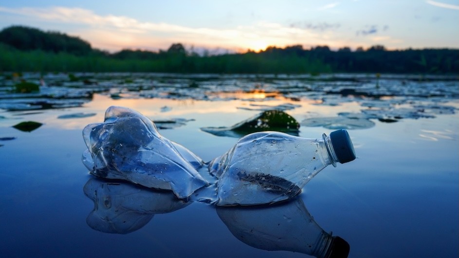 A plastic water bottle floating in a body of water.