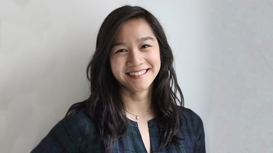 Adrienne Minh-Châu Lê: A woman with long dark hair, wearing a dark shirt, smiles for the camera.