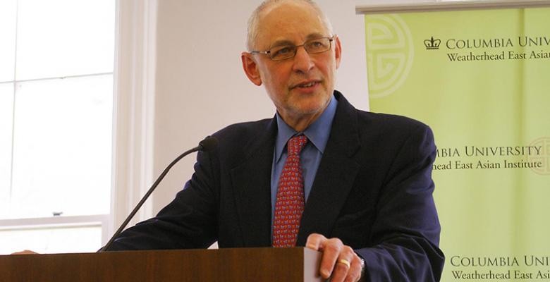 Prof Andrew Nathan standing at a podium 