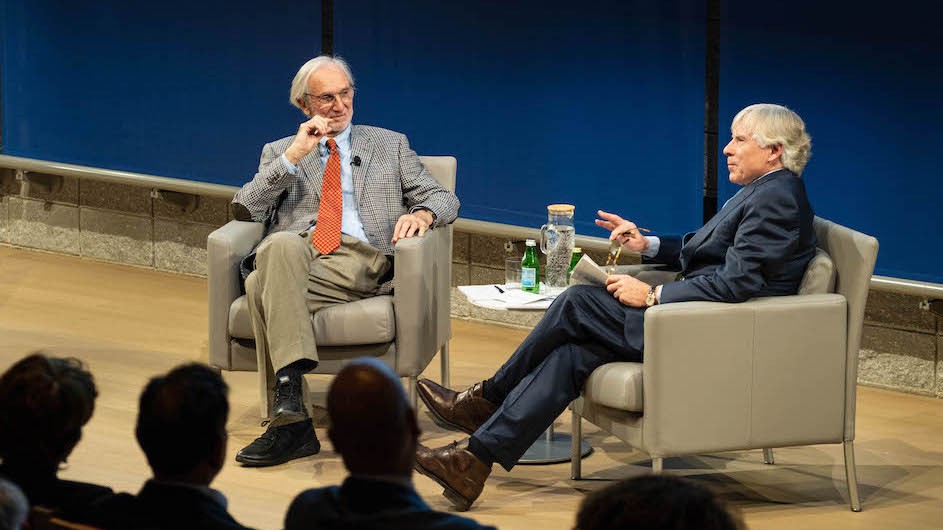Renzo Piano and Lee Bollinger: Two older men seated on a stage and talking to each other