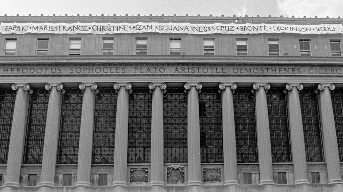 The 1989 Butler Banner hanging on the facade of Butler Library. a building with columns