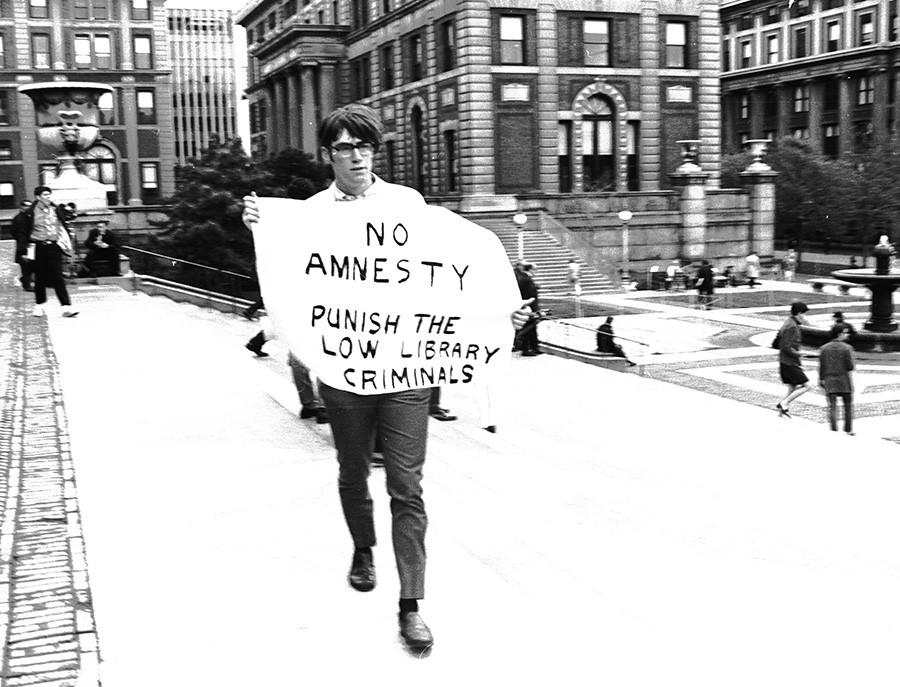 Student carrying a protest sign