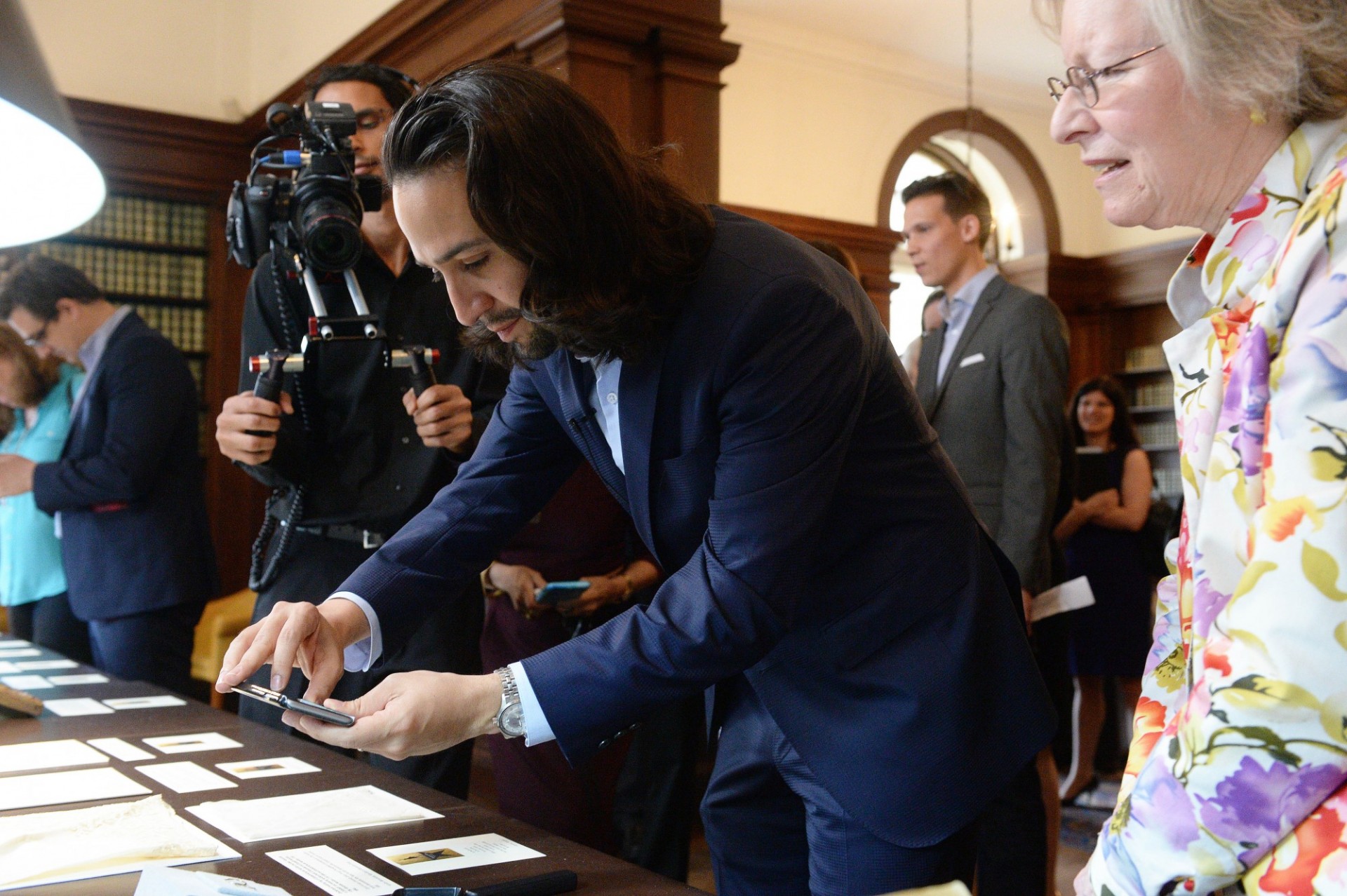 Lin Manuel Miranda photographing rare documents at Columbia University