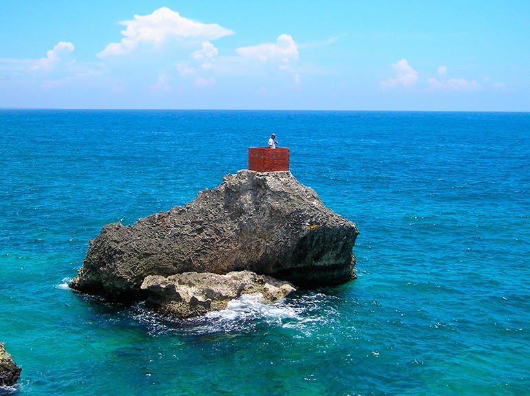 Fermín Ceballos Isolation, 2005, Photo of performance, Santo Domingo Photograph by Sayuri Guzmán, courtesy of the artist Rock in the middle of a blue ocean