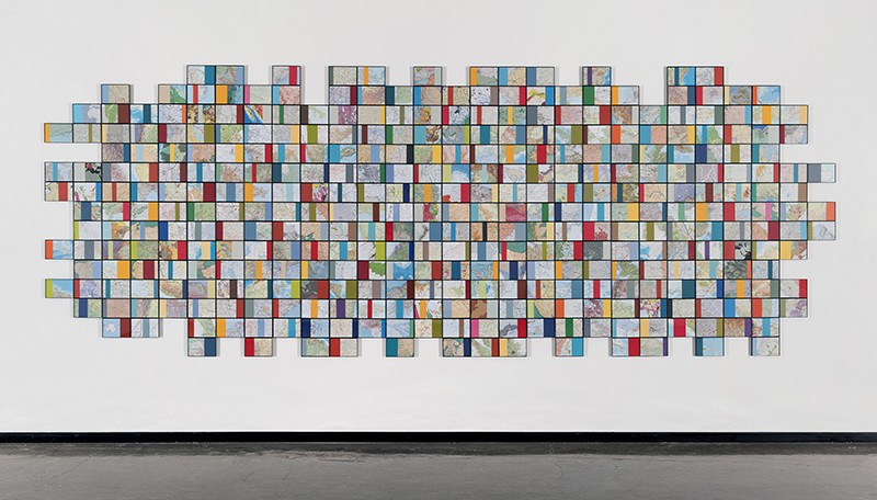 Nayda Collazo-Llorens, Geo Dis/connect #3, 2017, Wall installation with found maps, overall dimensions approx. 5 × 15 ft. Courtesy of the artist and LMAKgallery, New York Colorful art installation on white wall