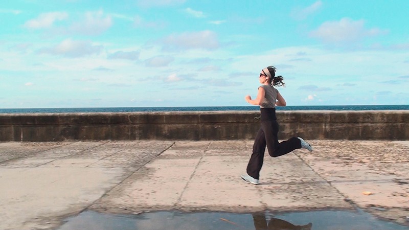 Woman running on a concrete dock