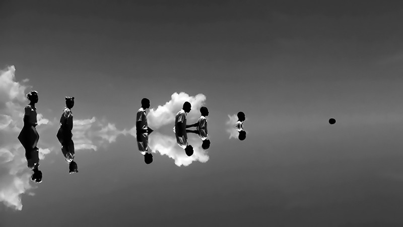 People walking with a cloudy background