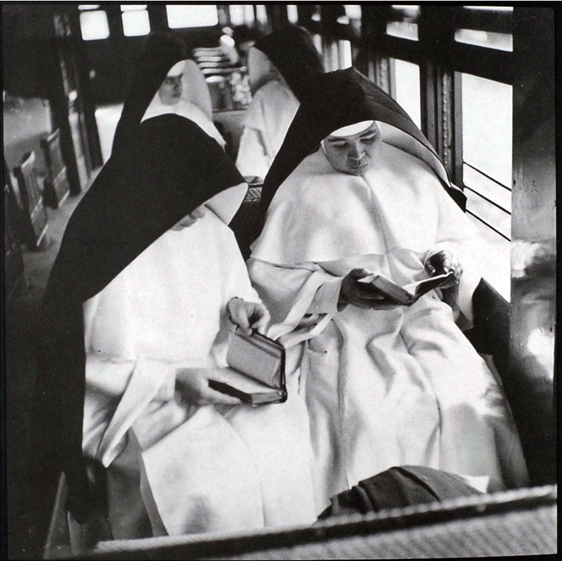 Photo Courtesy of the Delano Collection at Rare Book and Manuscript Library Four nuns sitting on wooden pews in a train. Photo Courtesy of the Delano Collection at Rare Book and Manuscript Library