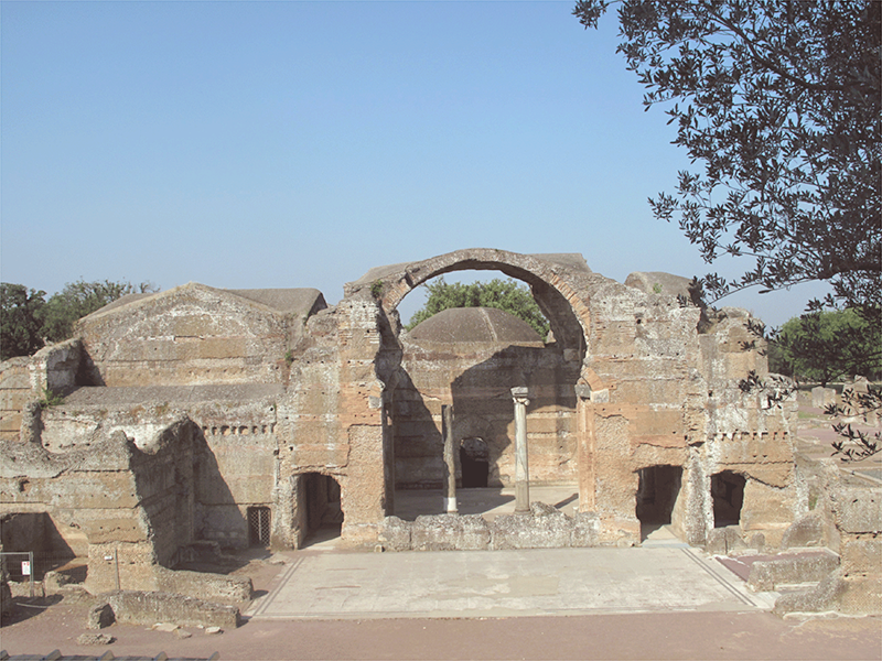 An arched entrance to a colonnaded room