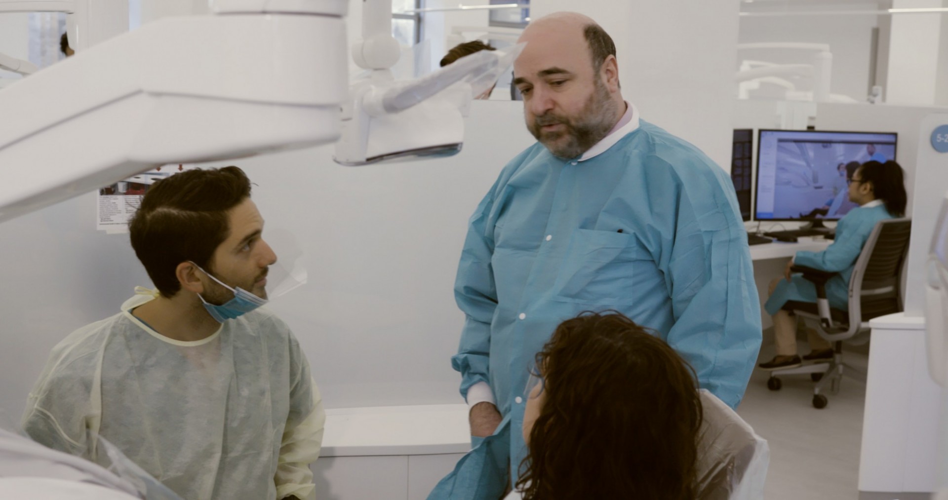 A dentists speaks to a patient
