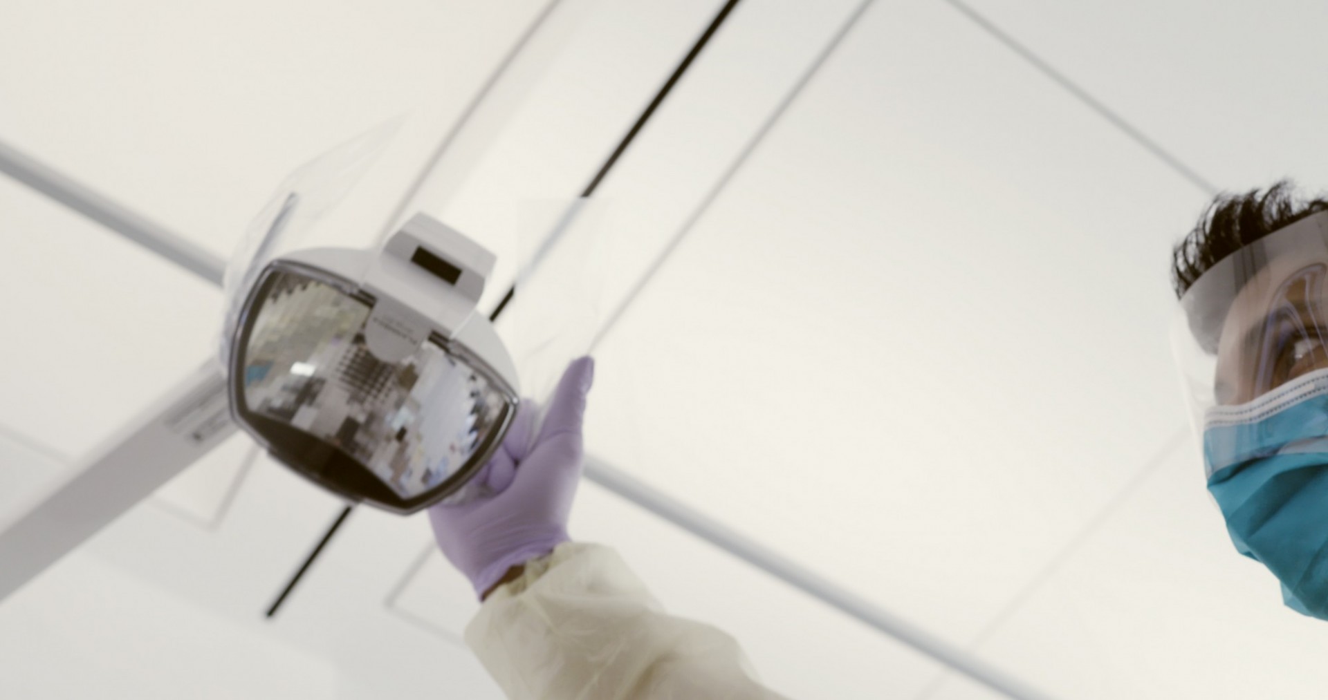 A dentist adjusts a light