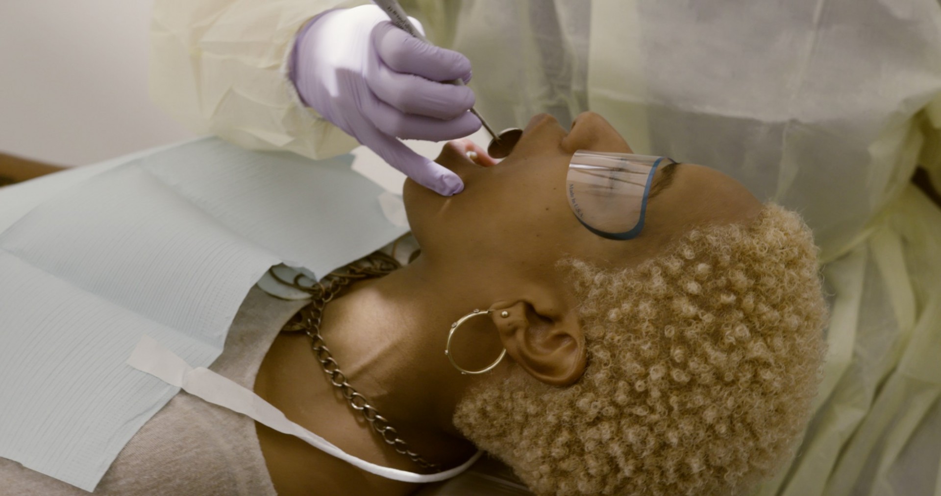 A patient with a dental instrument in her mouth