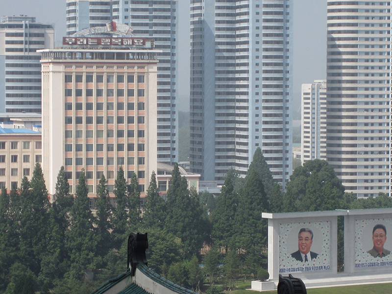 Downtown Pyongyang, with images of Kim Il Sung and Kim Jong-il, the current leader’s grandfather and father. The sign on top of the building reads “We Are Happy.” Photo Courtesy of Charles Armstrong Downtown skyline