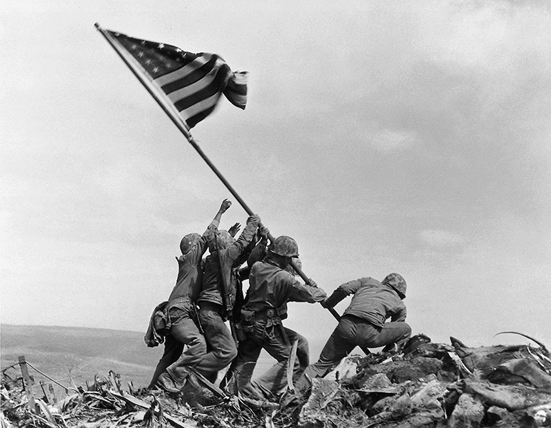 This iconic picture of Marines raising the American flag after capturing Iwo Jima won the 1945 Pulitzer for breaking news photography. Photo by Joe Rosenthal Four men lift a flag at Iwo Jima
