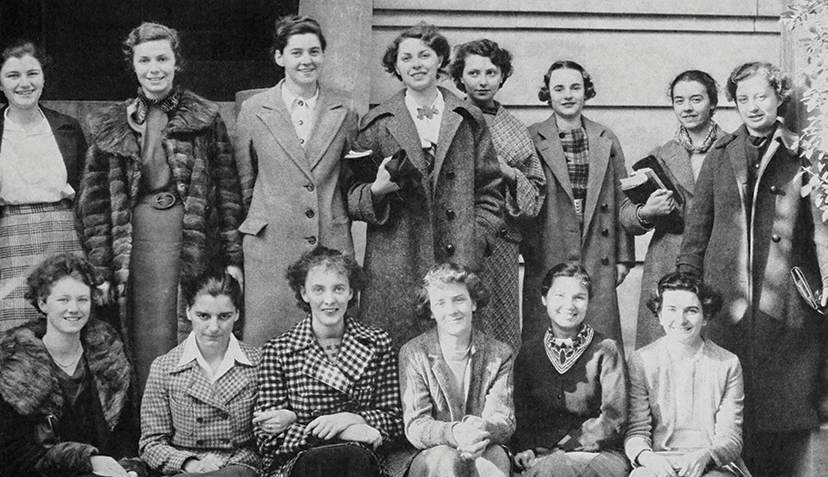 Two rows of women, one sitting, one standing
