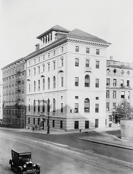 This photo from the 1920s shows the building flanked by row-houses on 117th Street and other residences on Amsterdam Avenue. Image Courtesy of Historical Photograph Collection, Columbia University Archives A white building with five stories on the corner of a street