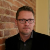 Charles King is awarded the Francis Parkman Prize. Charles King: A bespectacled man with closely cropped brown hair, leaning against a brick wall