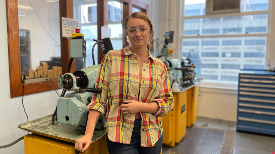 Clara Wilson standing in front of Columbia Blue lathe machines