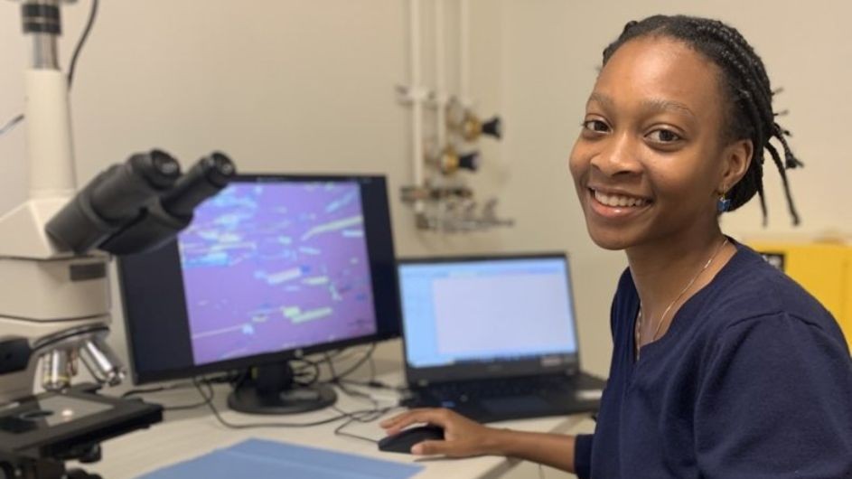 Image of Emma Charles, a Howard University REU student working at Columbia's MRSEC this summer, sitting in front of a computer