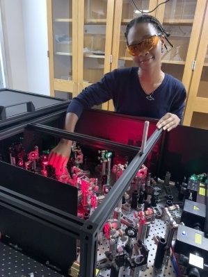 Howard University student Emma Charles, in front of a laser set up, spent her summer doing research in the Delor Lab at Columbia. Emma Charles in front of a laser set up