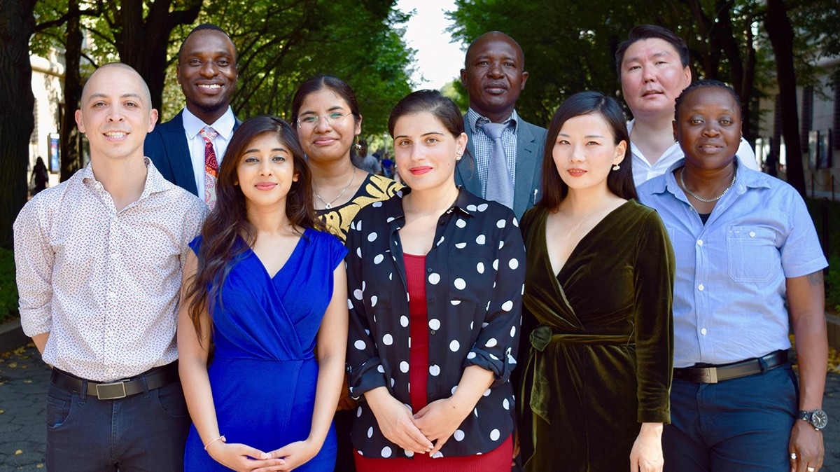 A group of people posing for a photo standing up