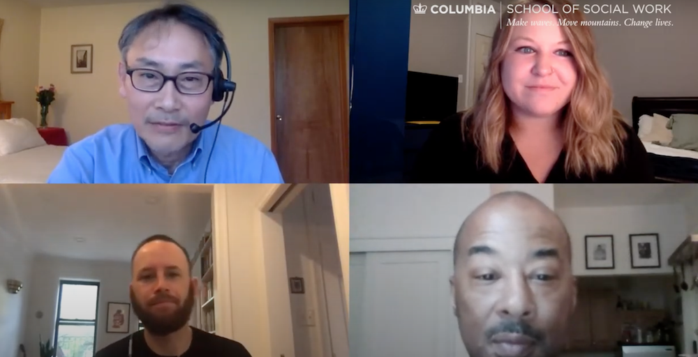Zoom image of four people on the screen-- upper left a man wearing glasses and a blue shirt, upper right a woman with a black shirt, lower right- just the man's face and lower left, a man with a black shirt