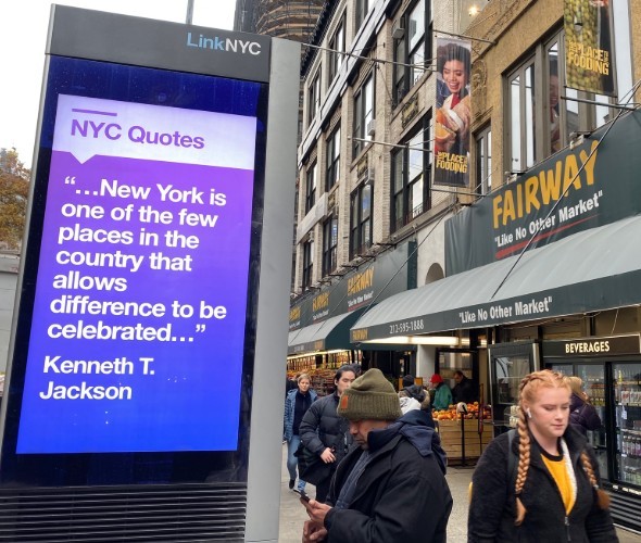 A quote displayed on an electric billboard on the street 