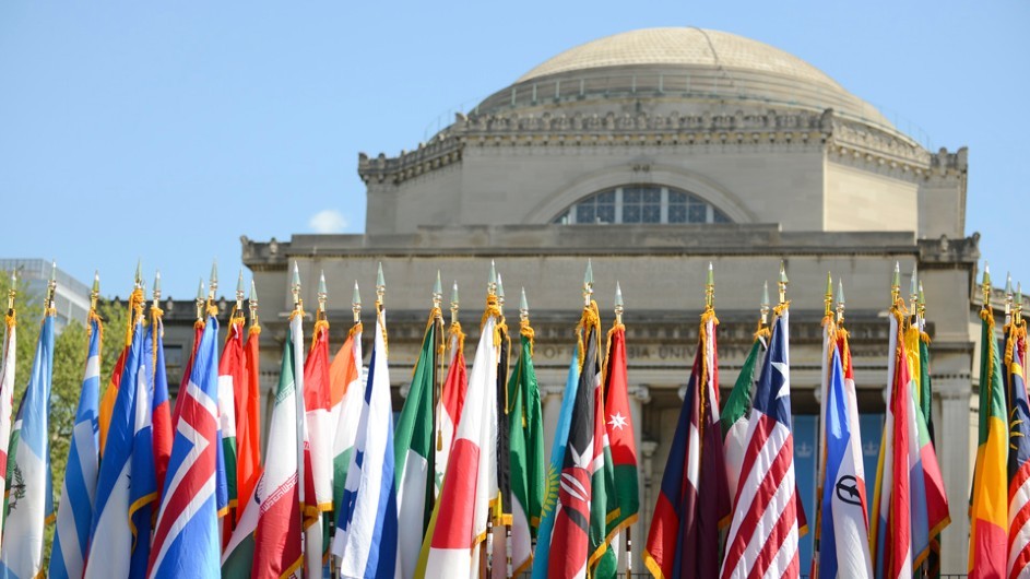 International flags on flag poles in front of Low Library, a domed building