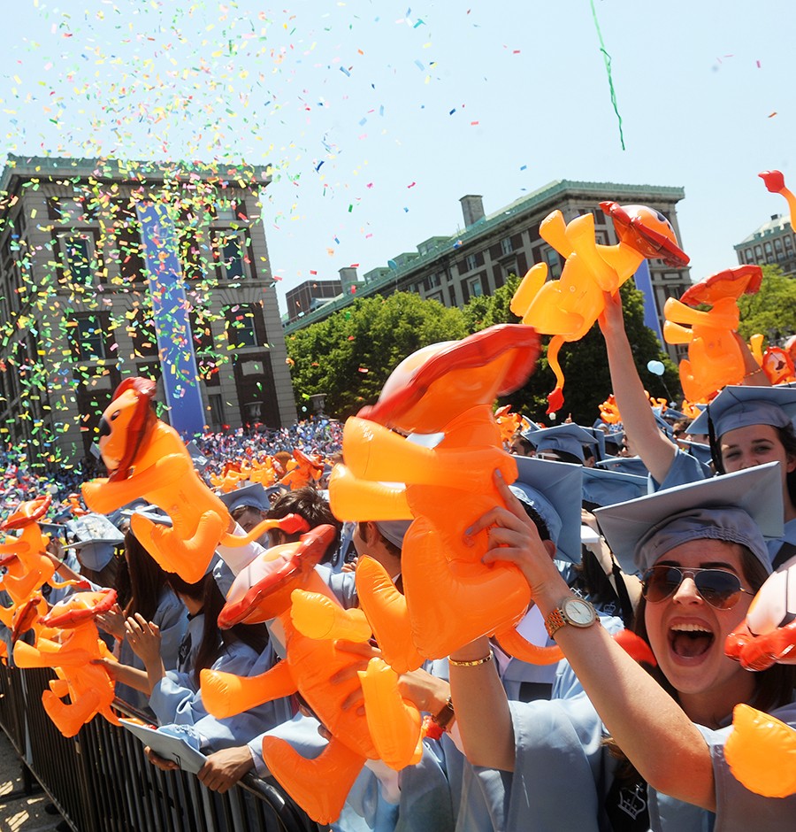 Graduating students throw confetti