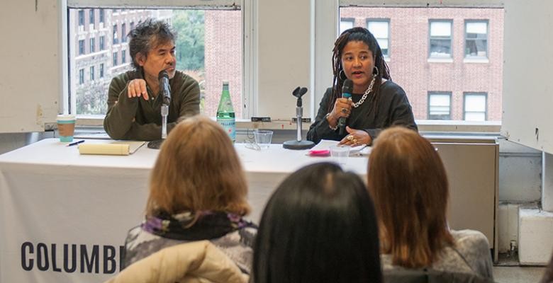 lynn nottage and david hwang are seated at a table speaking to a small group