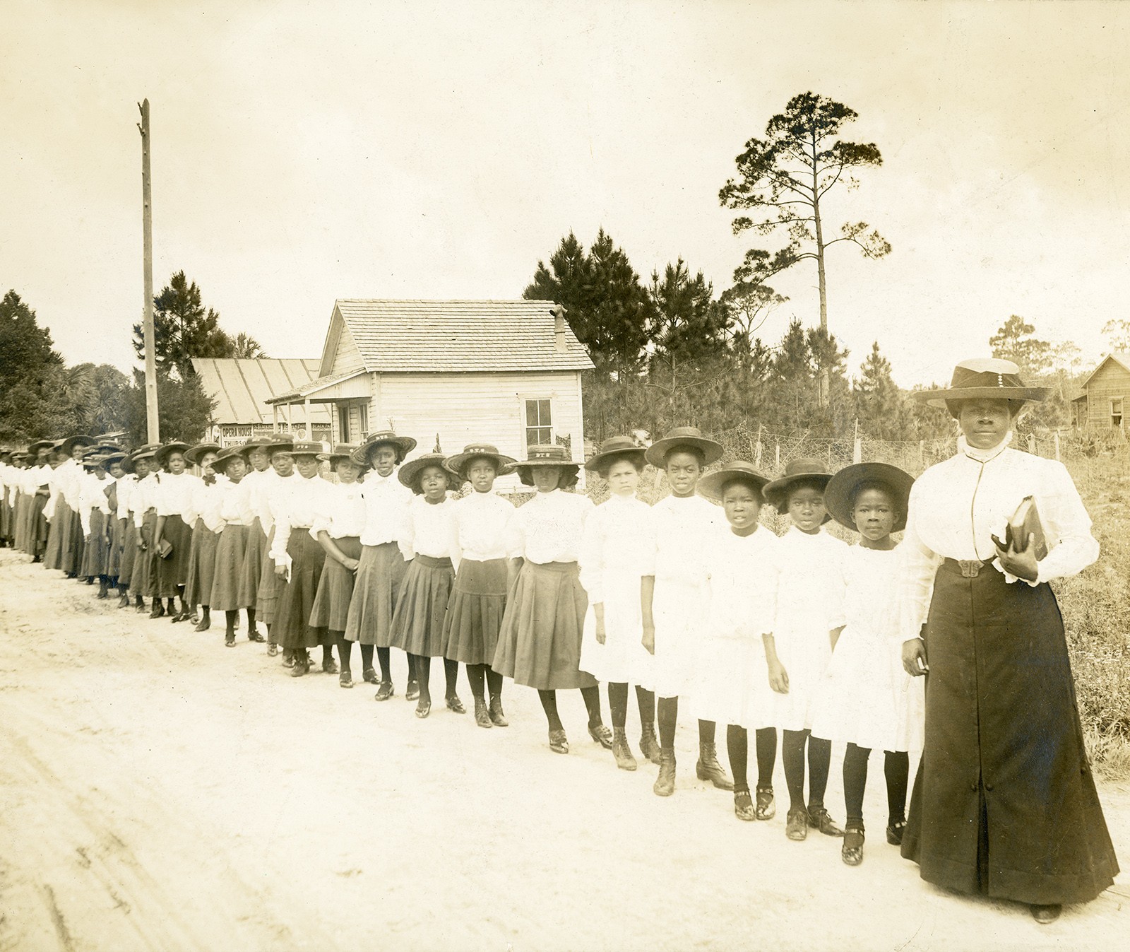 Mary McLeod Bethune with students from the Daytona (Florida) Literary and Industrial School for Training Negro Girls, about 1905. A diagonal line of African American schoolgirls and their teacher.