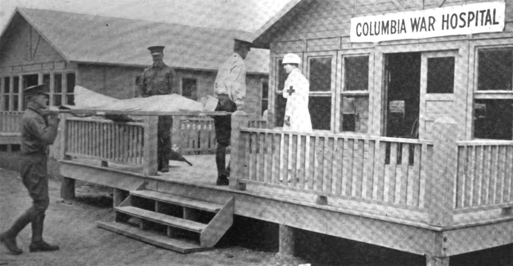 black and white image of soldiers carrying a wounded individual into Columbia War Hospital