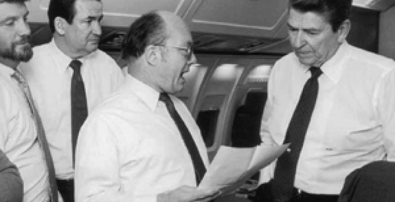 Center left, Ambassador Matlock translating a letter from a former Russian political prisoner while flying back from Reykjavik on Air Force One following a meeting with Gorbachev in October 1986. From left are: speechwriter Anthony R. Dolan and Patrick Buchanan. Ambassador Matlock