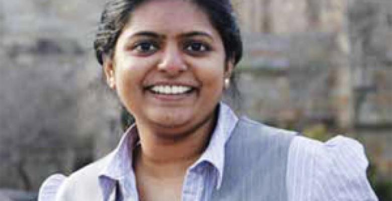 Raman left her career designing banking software in India to follow her passion for journalism. Smiling business woman looks at the camera