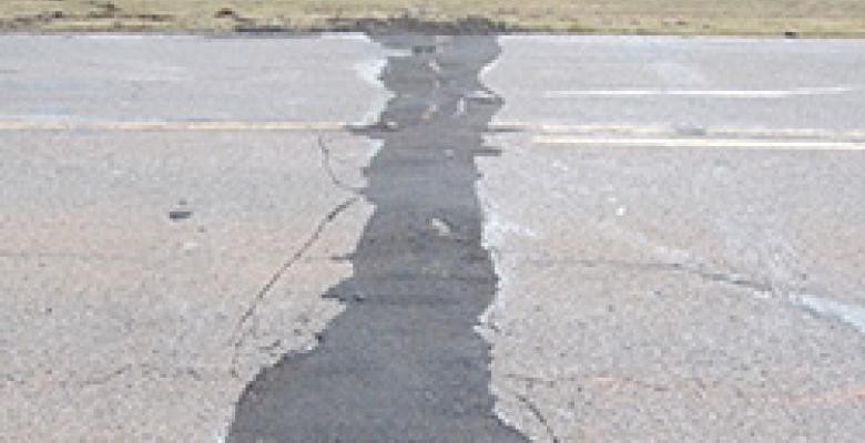 A 2011 magnitude 5.7 quake near Prague, Okla., apparently triggered by wastewater injection, buckled U.S. Highway 62. (John Leeman) A buckled roadway