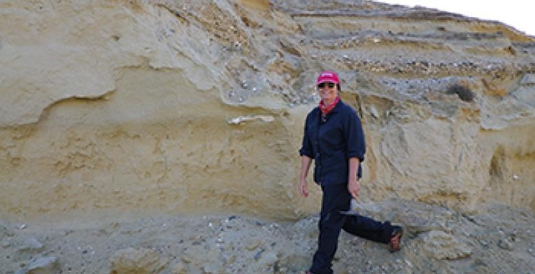 Along ancient exposed shorelines like this one in South Africa, Raymo is measuring how high the seas stood 3 million years ago. (Alessio Rovere) Maureen Raymo standing in front of a wall of rock