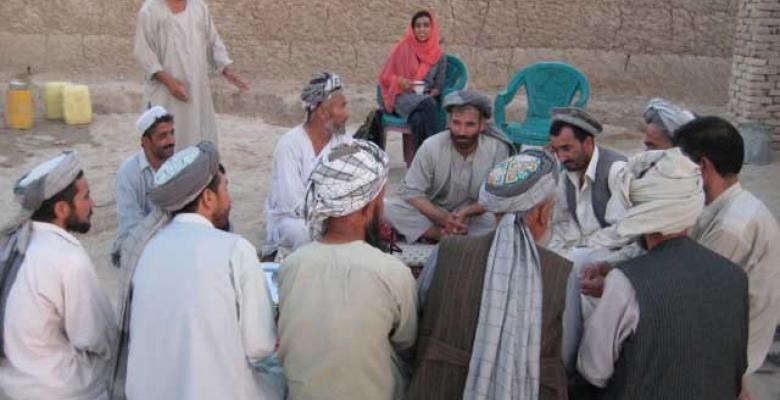Mukhopadhyay with former mujahideen commanders and others in Mazar-i-Sharif, Afghanistan, in 2008. Group of men sitting in a circle