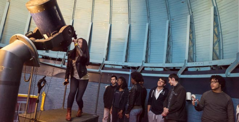 Students looking through a telescope